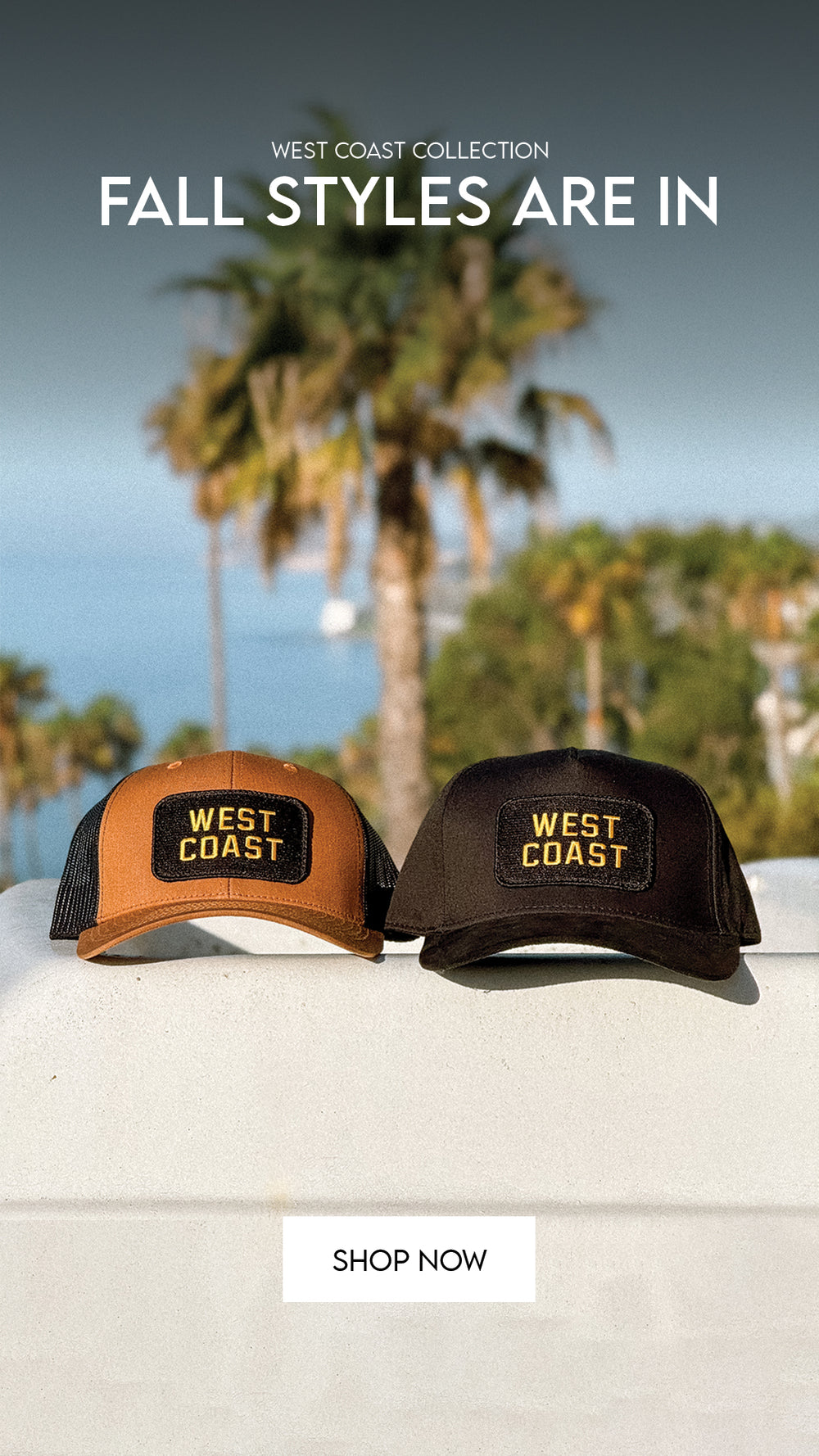 Two trucker-style caps from West Coast Collection are displayed on a white ledge with a blurred beach and palm tree background. One cap is tan with black mesh side panels and a black patch with yellow text, and the other is dark brown with similar black mesh side panels and a black patch with yellow text.