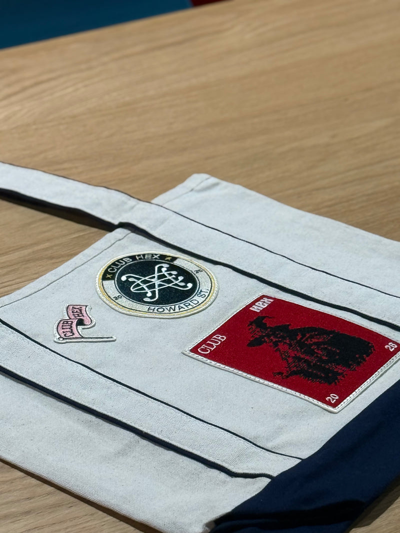 Hand holding a stack of custom embroidered patches