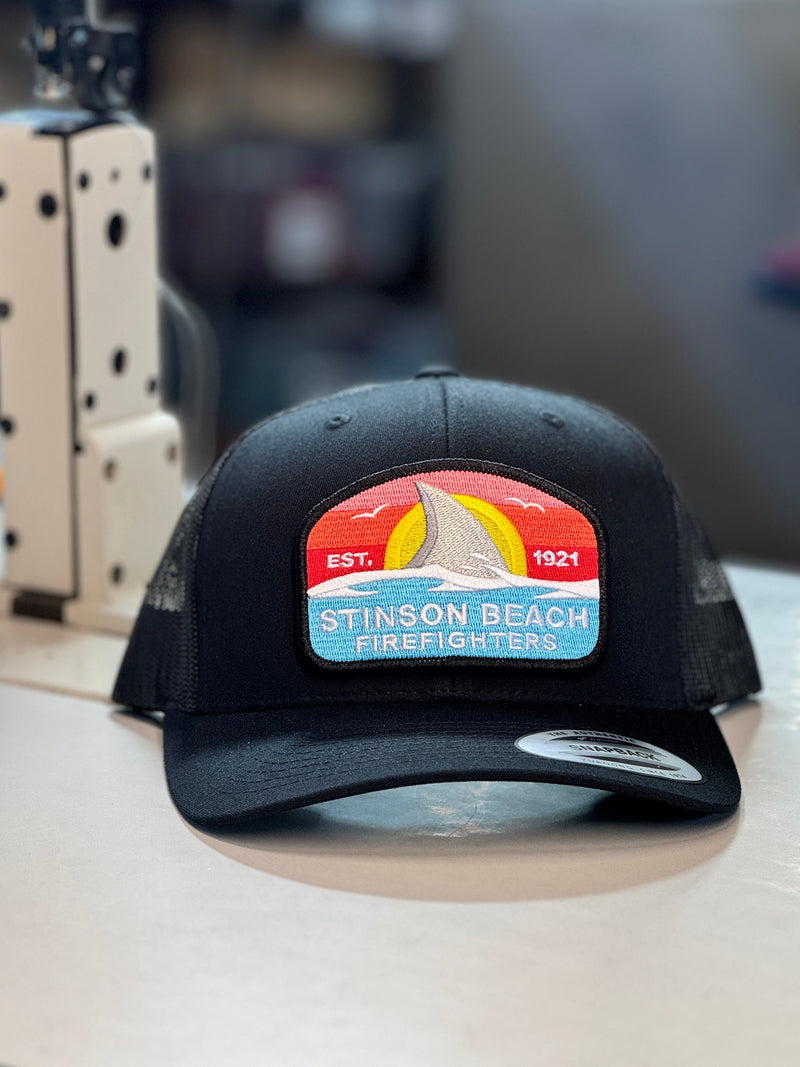 Custom patch trucker hat on a workbench