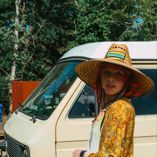 Straw Hat by Tommy Breeze with a person standing by a VW bus in Marin County