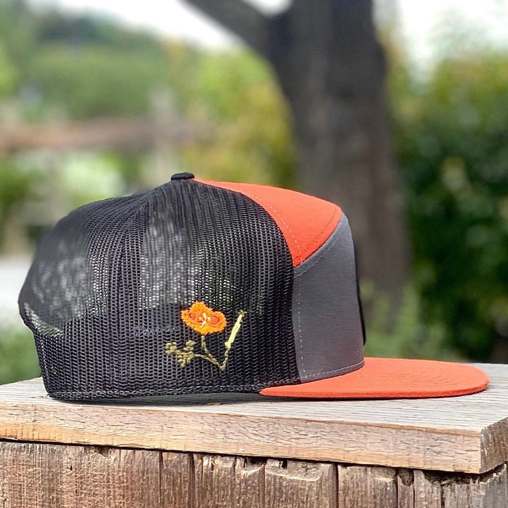 NEW We The Essentials Black on Black Trucker Hat with Orange Patch