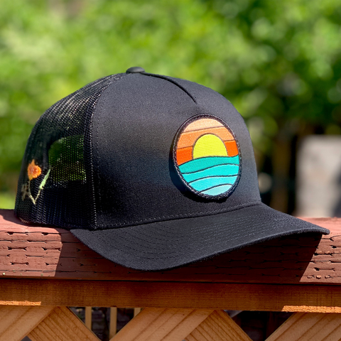 California Poppy Curved Brim Trucker (Black) with Serenity Patch